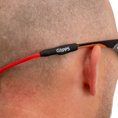 Close-up of universal silicone rubber grips on the GRIPPS® Safety Glasses Tether MKII securely attached to the arms of a pair of industrial safety glasses.